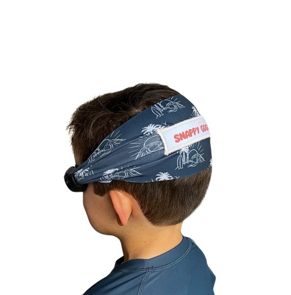 Child wearing a navy swim goggles with a floatable fabric strap - Snappy Goggles