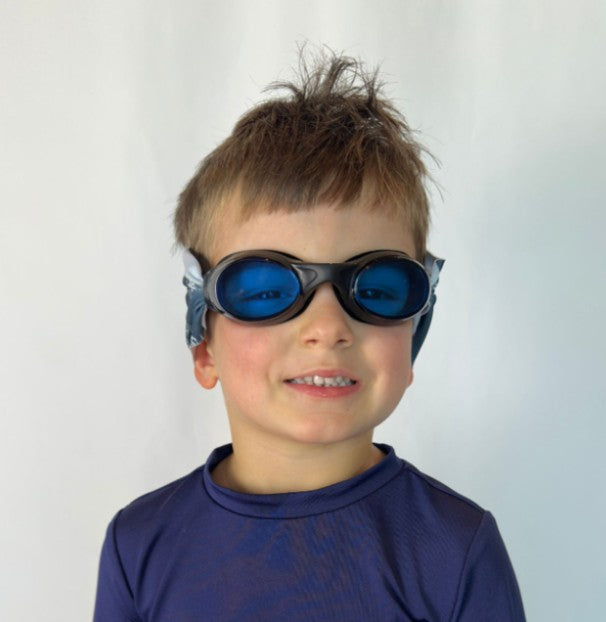 Child wearing blue beach vibes swim goggles with a fabric strap that doesn't pull hair - Snappy Goggles