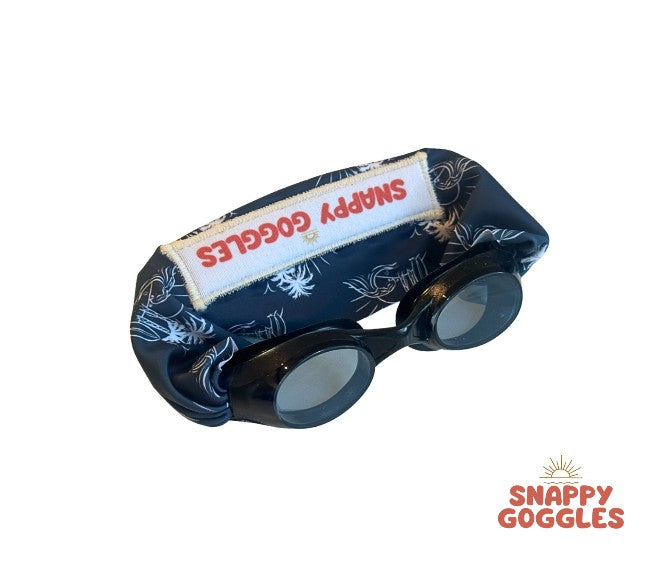 black frame swim goggles featuring a blue island vibe fabric strap that is adjustable and floatable - Snappy Goggles