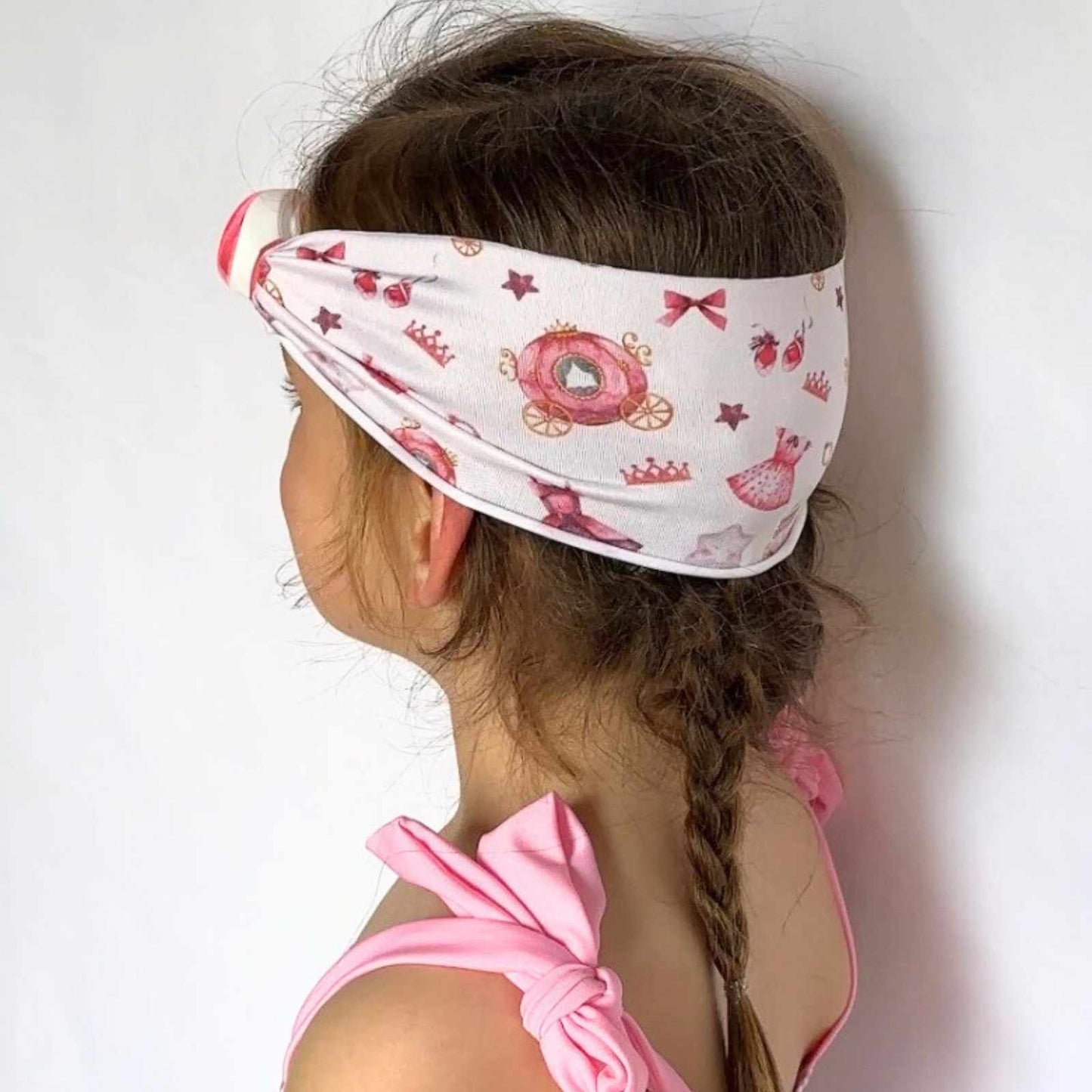 Child wearing a pink princess fabric strap swim goggles - Snappy Goggles