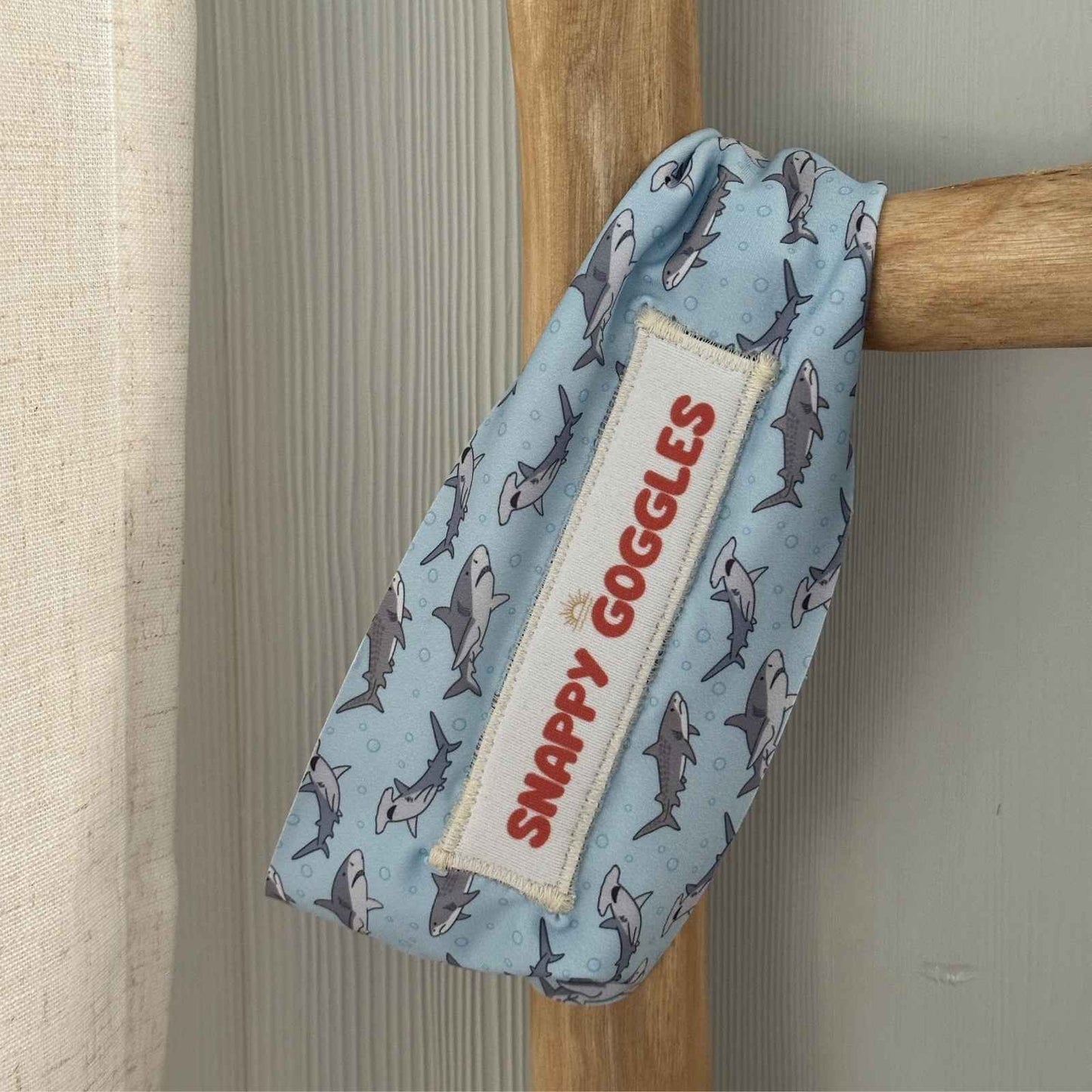 Shark-patterned fabric strap swim goggles case with 'Snappy Goggles'