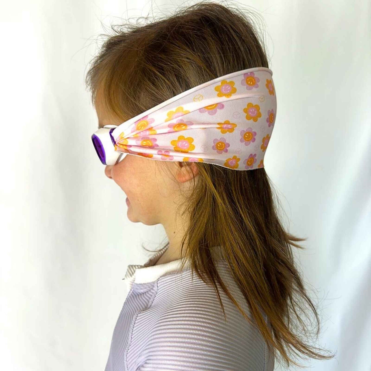 side view of orange and purple flowers and peace sign kids swim goggles with adjustable fabric strap and floatable goggles – Snappy Goggles