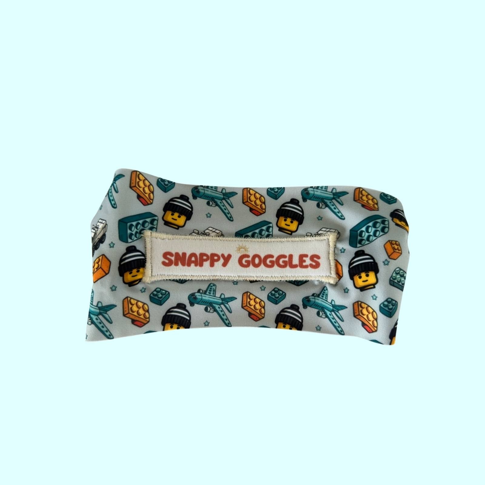 back view of blue Aqua Blocks kids swim goggles with adjustable, fabric strap – Snappy Goggles