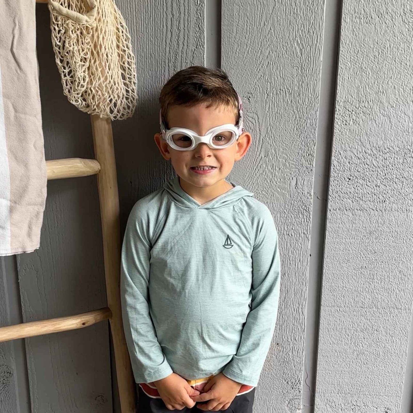 Child wearing camo swim goggles that are the best swim goggles for kids. 