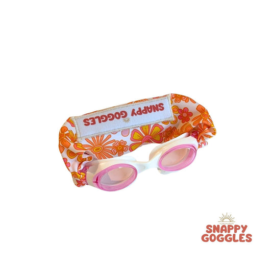 Pink yellow and orange floral swim goggles with a colorful floral fabric strap - Snappy Goggles