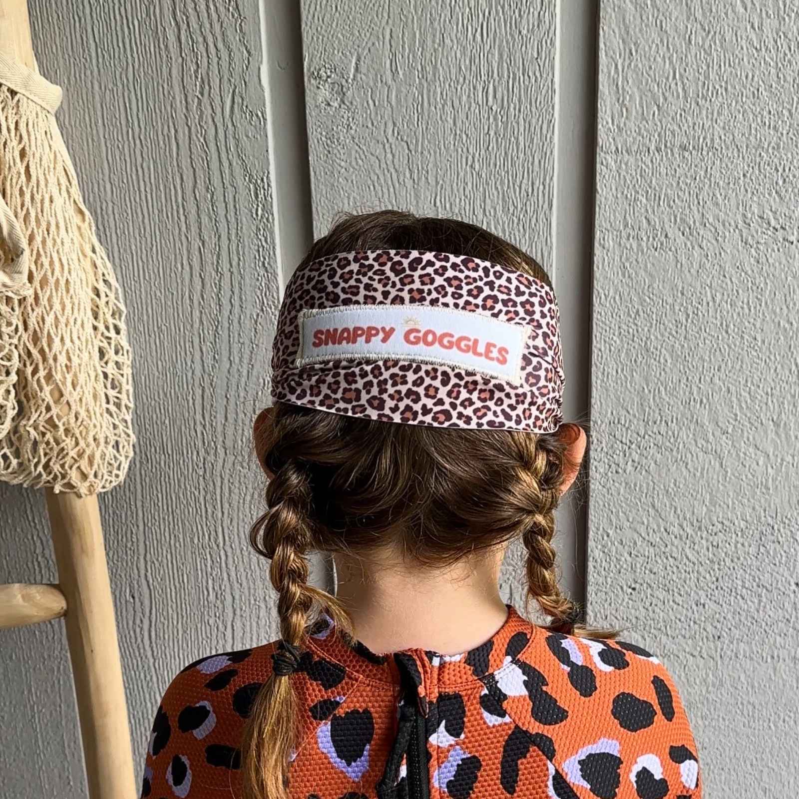 back view of leopard kids swim goggles with adjustable, fabric strap – Snappy Goggles