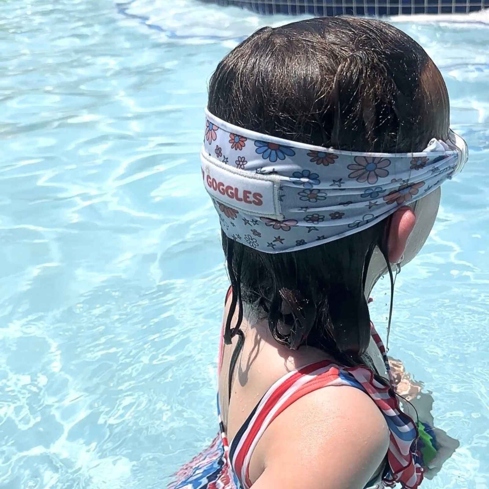 Child wearing a floral fabric strap swim goggles swimming in the pool -Snappy Goggles