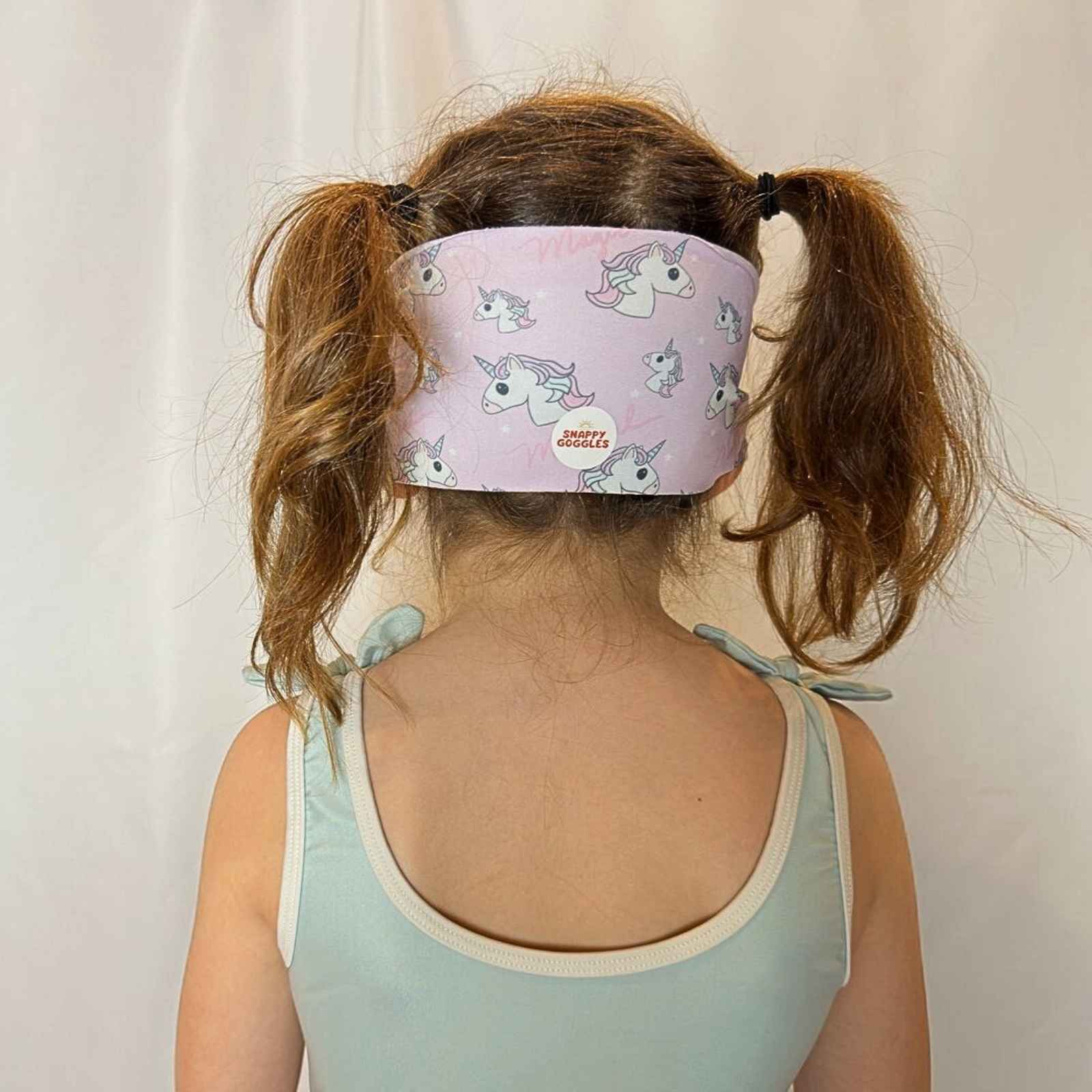 back view of pink and purple unicorn kid swim goggles with adjustable, fabric strap – Snappy Goggles